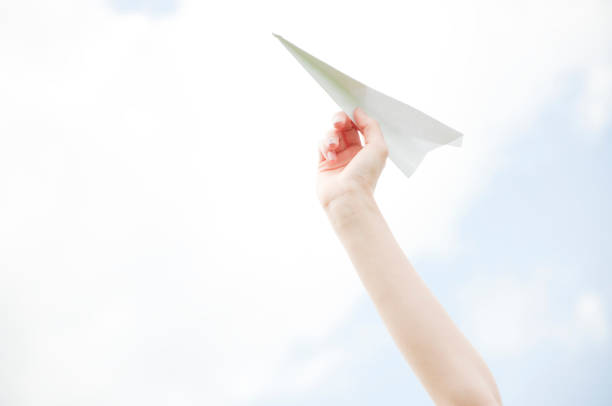 istock Woman holding paper airplane in hand 674170790