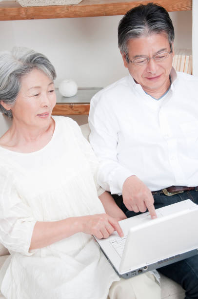 istock Look at laptop smiling senior couple 674171536