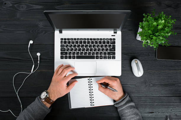 istock Directly above view of human hands typing on laptop 674171774