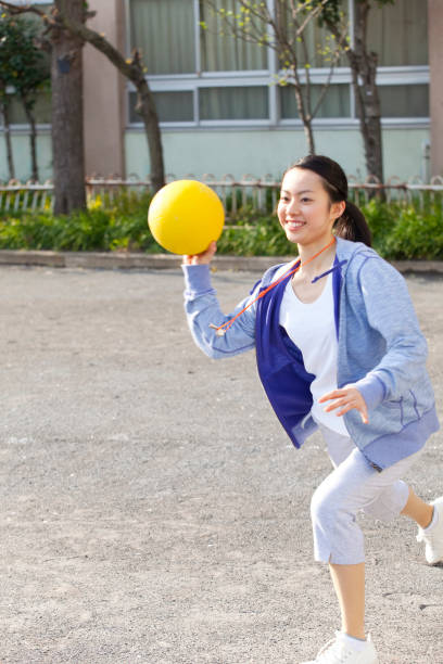 istock Female teachers throwing dodgeball 674172088