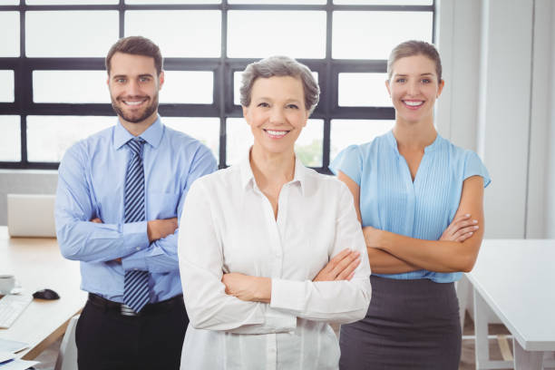 istock Confident business people with arms crossed in office 674177300