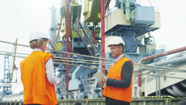 People in Hard Hat are Talking in Industrial Environment