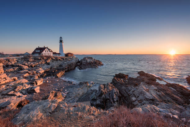 Sunrise at Portland Head Light House This is a shot i took in late march of portland head light house right as the sun broke over the horizon. fort william stock pictures, royalty-free photos & images