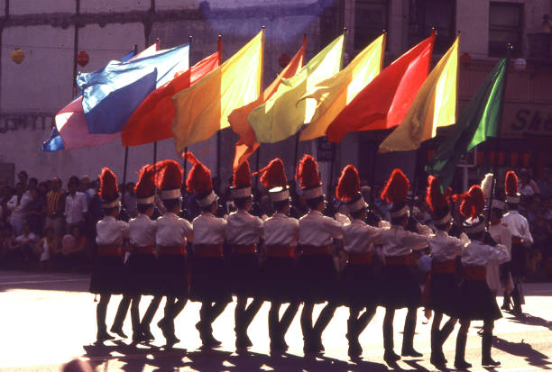 Backlit marching band flags and parade in Los Angeles California