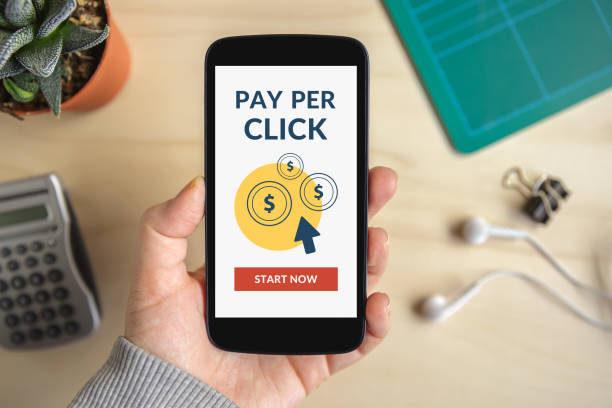 istock Hand holding smart phone with Pay Per Click concept on screen 674186676