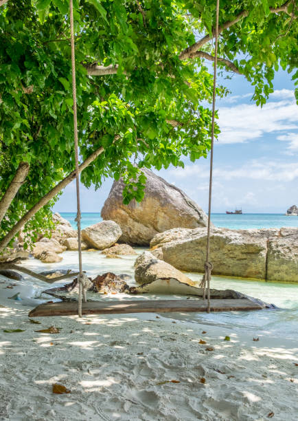 istock Wooden swing on white sand shady at lipe 674187710