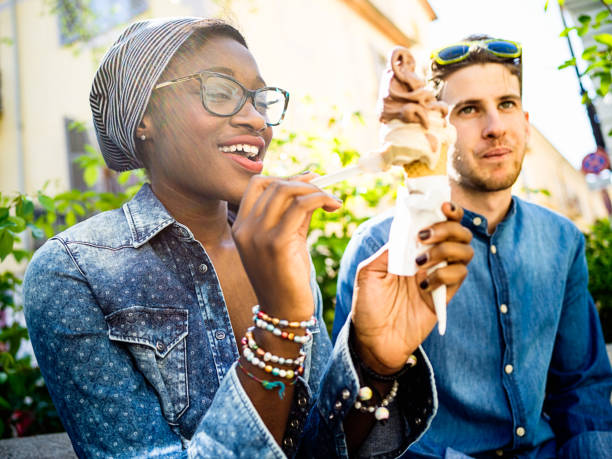 istock Young mixed race couple with ice cream 674188276