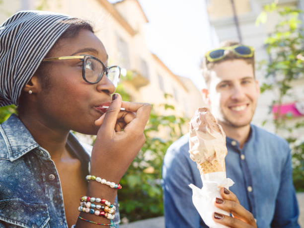 istock Young mixed race couple with ice cream 674188310