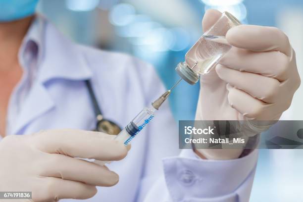 Doctor Gaining In A Syringe Medication Stock Photo - Download Image Now - Vaccination, Injecting, Doctor