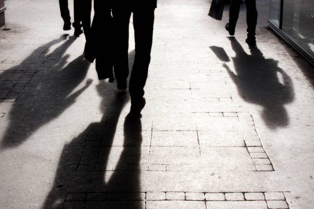 istock Blurry shadow and silhouette of people on the sidewalk 674198668