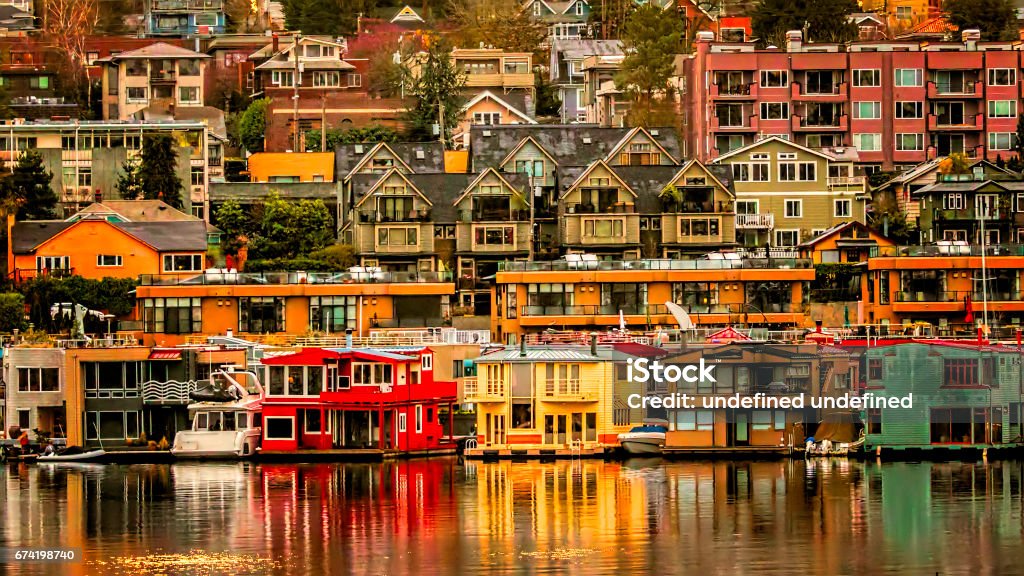 View of Colorful Homes from Across Lake Union Beautiful colors reflected in Lake Union during early morning sunrise. Seattle Stock Photo