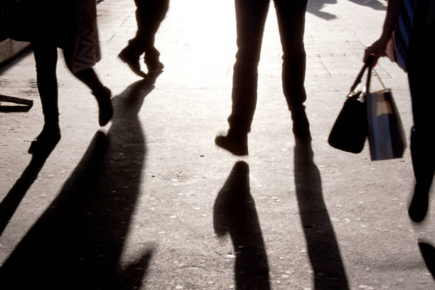 istock Blurry  legs on city sidewalk 674198846