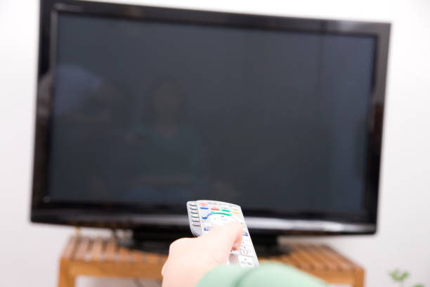 istock Women with a remote control at hand 674199876