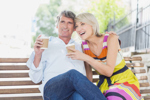 istock Happy couple with coffee cups in park 674199954