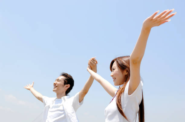 istock Couple raises his hands to the sky 674205672