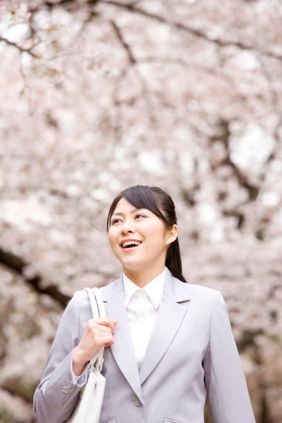 istock Woman walks under the cherry tree 674208184