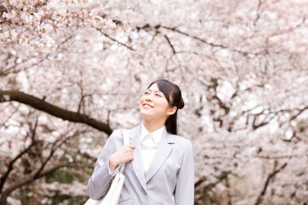 istock Woman walks under the cherry tree 674208198