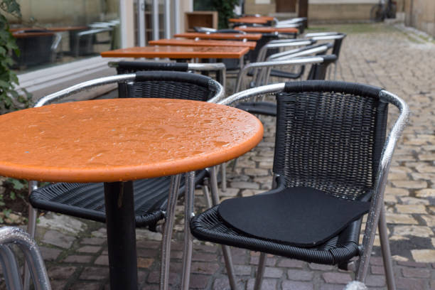 istock stackabel cafe chairs and table on a rainy day in south germany 674212732