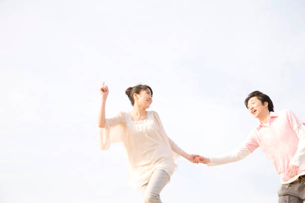 istock Couple holding hands and running 674212760