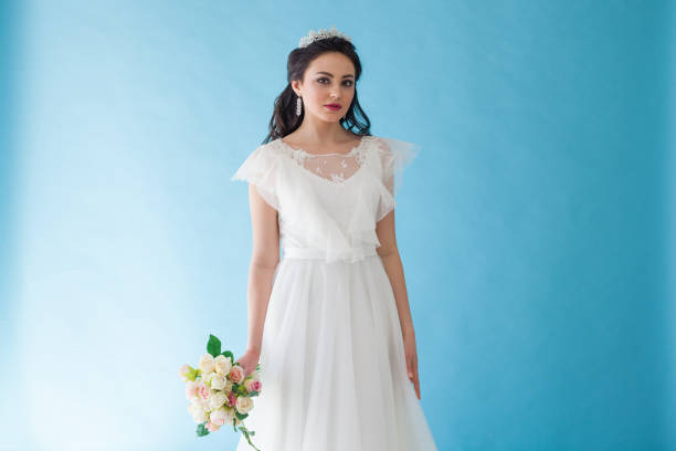 istock Princess Bride in a white dress with a Crown on a blue background 674212812
