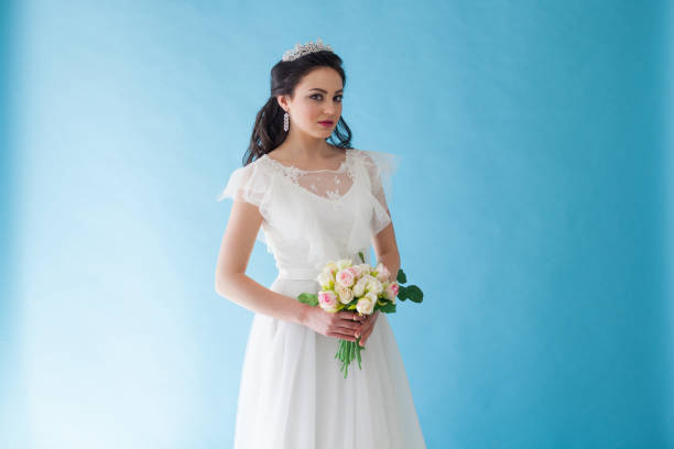 istock Princess Bride in a white dress with a Crown on a blue background 674213234