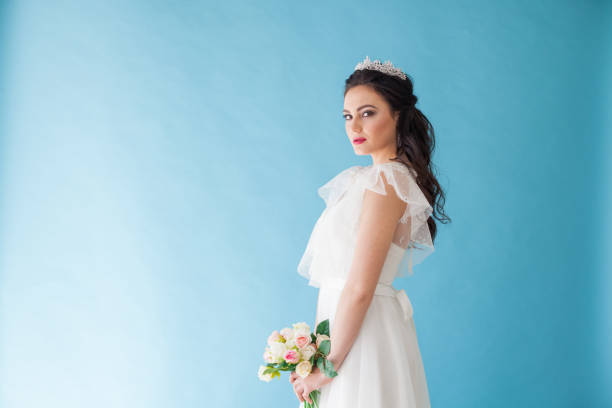 istock Princess Bride in a white dress with a Crown on a blue background 674214372