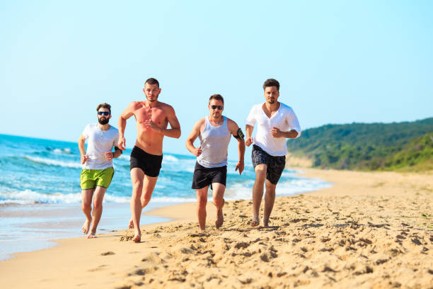 istock Group of friends running on beach 674220242