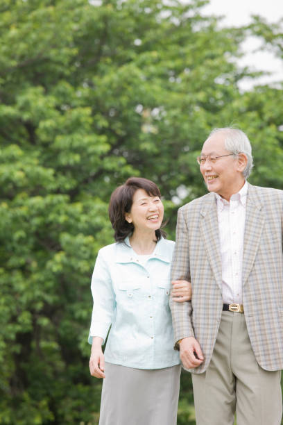 istock An elderly couple to walk the Park arms 674227184
