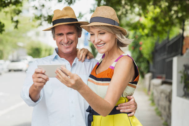 istock Happy couple looking at mobile phone 674229274