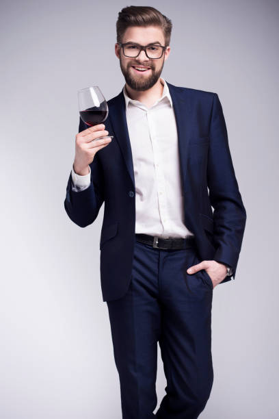 istock Handsome man with a beard holding a glass of wine 674229286