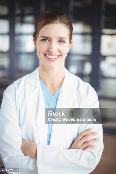 Portrait Of Smiling Female Doctor With Arms Crossed Stock Photo - Download Image Now