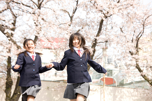 Two people holding hands, runs women's junior high school students