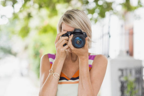 istock Woman taking photograph from camera 674231552