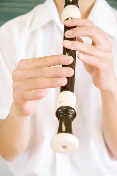 istock Male junior high school students blow the recorder at hand 674234098