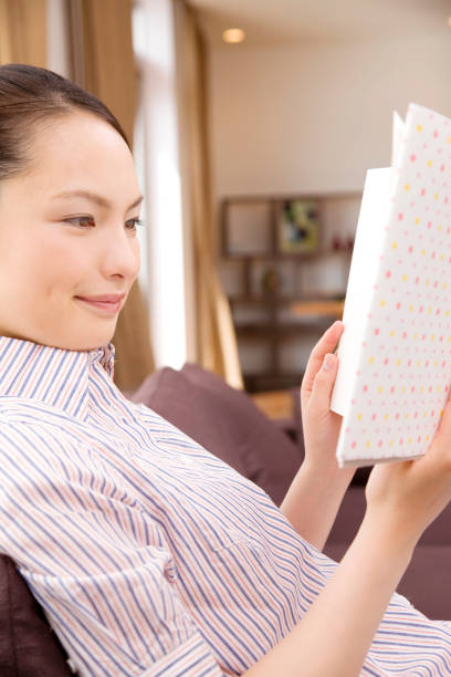 istock Women sitting on the sofa and read it from magazine 674237512