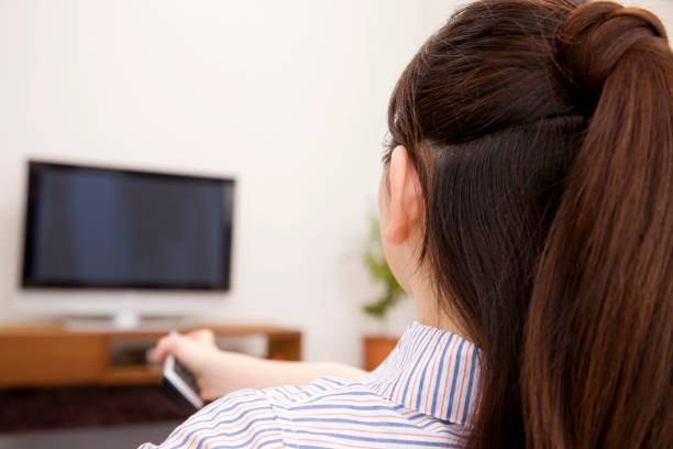 istock Women trying to change TV channels 674237568