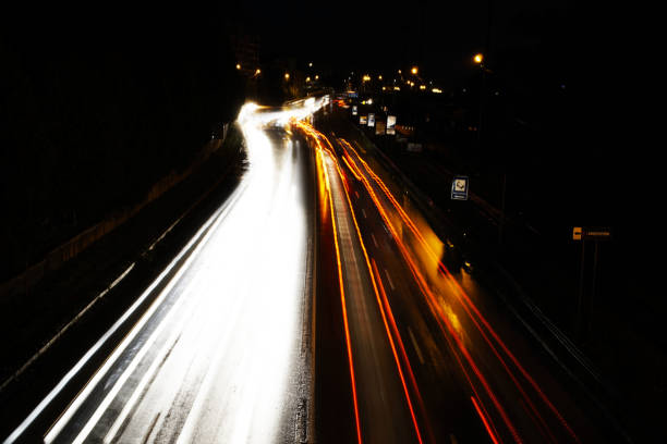 istock Light lines of fast driving car lights in the night. 674237576