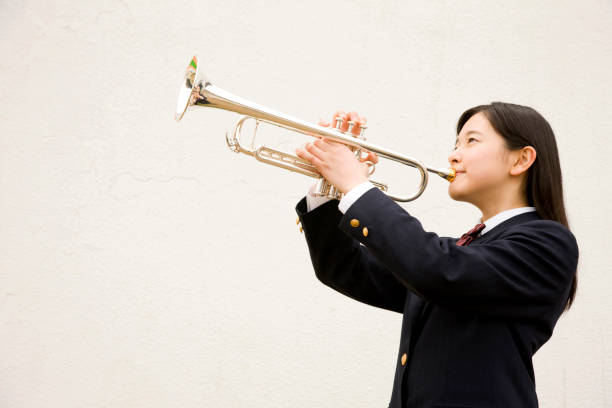 istock Female junior high school student trumpet 674238636