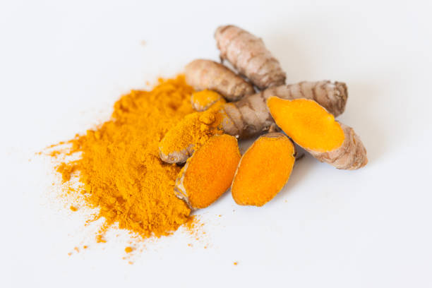 istock Turmeric roots with turmeric powder isolated on white background 674238902