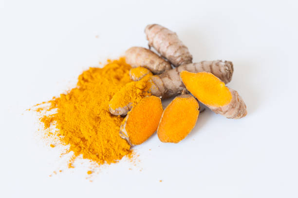 istock Turmeric roots with turmeric powder isolated on white background 674239030