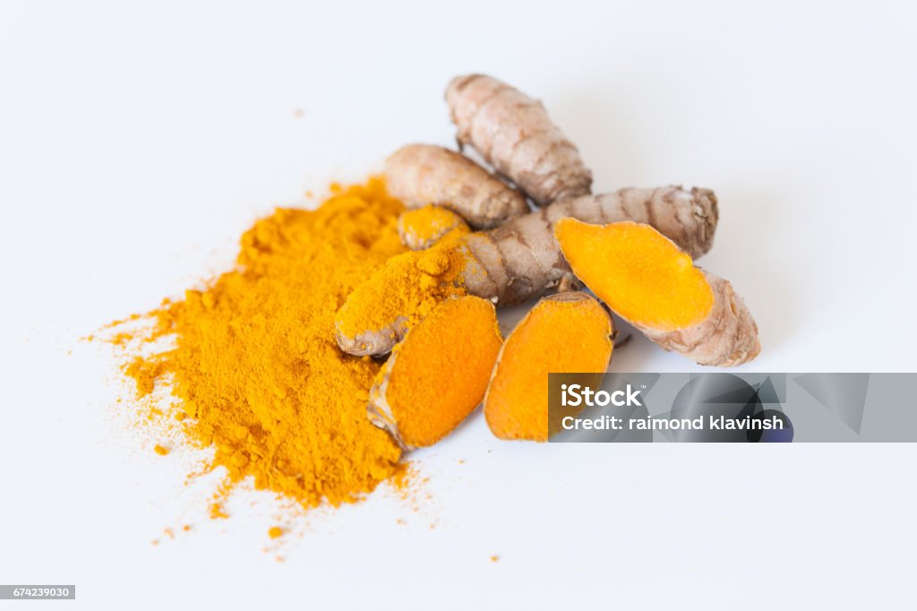 Turmeric roots with turmeric powder isolated on white background Turmeric roots with turmeric powder. Spice symbol. For food design, restaurant, store, market, health care products. Can be used as logo, price tag, label Cut Out Stock Photo
