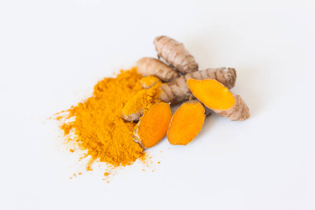 istock Turmeric roots with turmeric powder isolated on white background 674241154