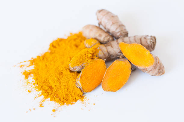 istock Turmeric roots with turmeric powder isolated on white background 674241554