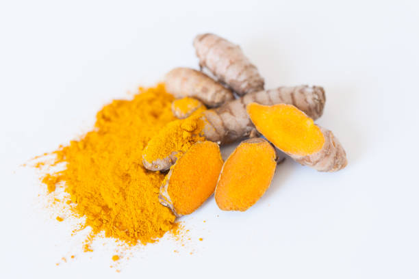 Turmeric roots with turmeric powder isolated on white background