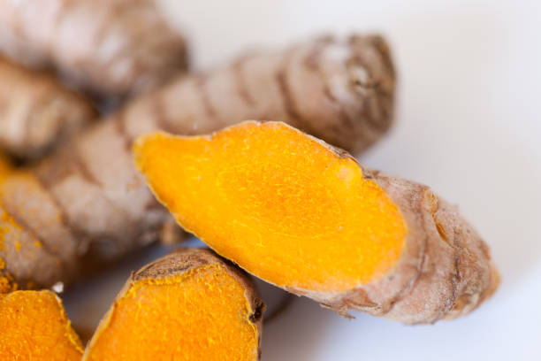 istock Turmeric roots macro with turmeric powder isolated on white background 674243402