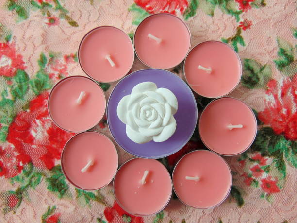 istock pink and purple scented candles with white flower 674243628