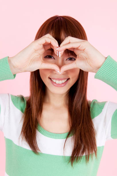 istock Woman with hands making heart 674244960