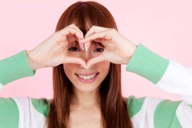 istock Woman with hands making heart 674244972