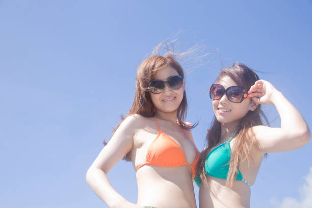 istock Two blue sky under the sunglasses swimsuit women 674250834