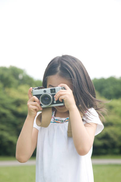 istock Girl shooting with a camera 674250918